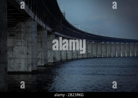 The concrete pillars holding up the Öresund bridge on a dark gloomy day by the sea in Malmö, Sweden Stock Photo