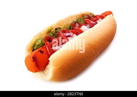 Carrot vegan hot dog with relish, ketchup and onions isolated on a white background. Healthy plant based meatless meal concept. Stock Photo