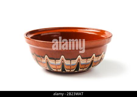 Old clay cup with a multi-colored pattern isolated on white Stock Photo