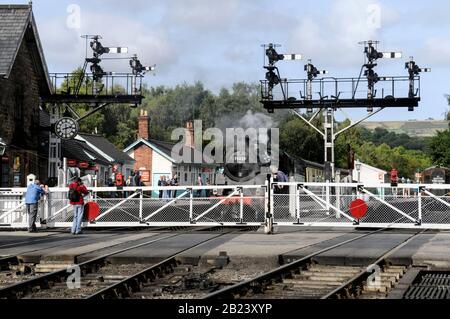 A level rail crossing at Grosmont rail station, part of the North Yorkshire Moors Railway (NYMR) in the Yorkshire Moors national park Britain .   The Stock Photo