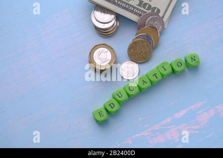 top view of education text and coin on table. saving money for education concept Stock Photo