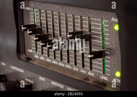 Old black dusty controls of an audio equalizer from a guitar amplifier Stock Photo