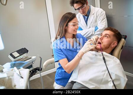 Male patient at female dentist having toothache Stock Photo