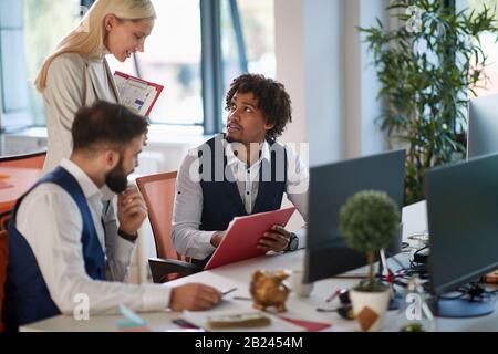 Successful business people and software developers working as a team in office. Stock Photo