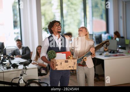 Happy young diverse colleagues dance having fun in office.New job at modern business company. Stock Photo