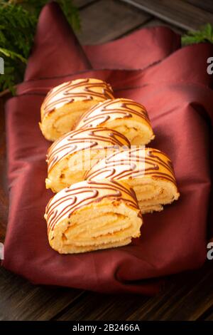 Artic roll cake desert with milk cream in slices, vertical retro image Stock Photo