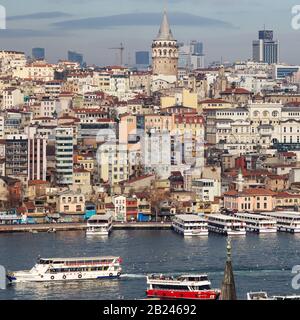 Istanbul / Turkey - 01/20/2019: View of Cityscape with Galata Tower and Golden Horn from garden of the Suleymaniye Mosque. Stock Photo