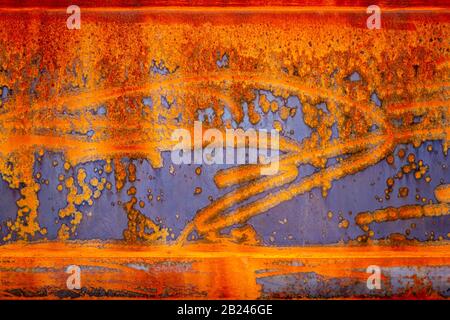 Stripes and patterns of rust on the side of a metal boat Stock Photo
