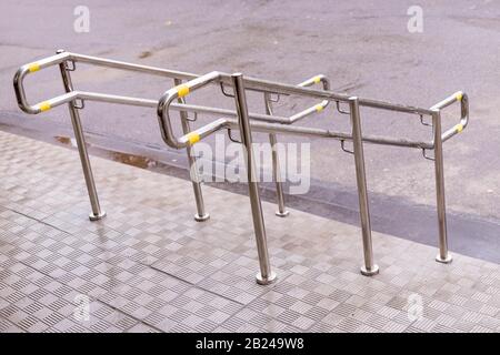 Stainless steel handrails are installed on the teps.safe movement.Holder handrail railing stainless steel .Chrome handrail Stock Photo
