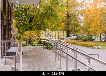 Stainless steel handrails are installed on the teps.safe movement.Holder handrail railing stainless steel .Chrome handrail Stock Photo