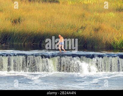 The Venta waterfall in Kuldiga, Latvia is the widest waterfall in Europe at 240 meter wide Stock Photo