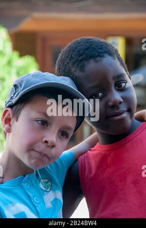 White boy and black boy smiling with grimaces Stock Photo