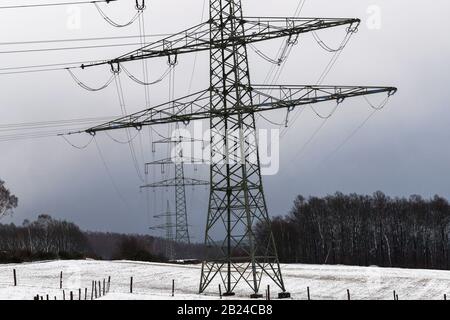 Electricity pylons in a winter landscape with snow. UK Stock Photo - Alamy