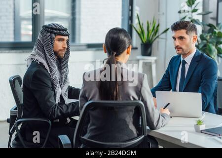 multiethnic business partners on meeting with translator in office Stock Photo