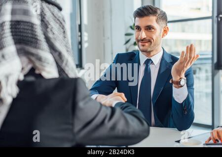 positive multiethnic businessmen shaking hands on meeting Stock Photo