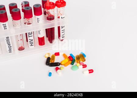 test tubes with blood samples and lettering near pills isolated on white Stock Photo