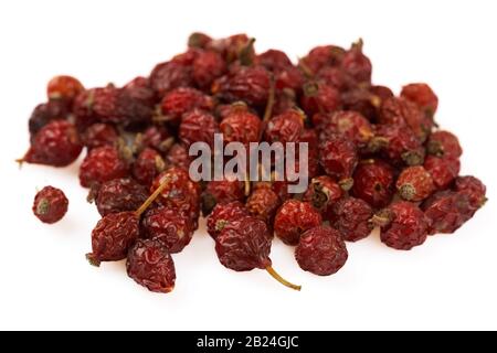 Heap of dried rose hips isolated on white Stock Photo