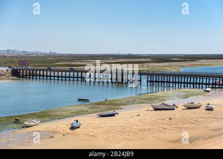 An old bridge on Faro Beach, across the Ria Formosa. Portugal Algarve Stock Photo