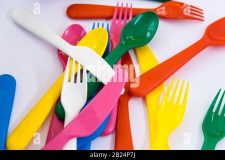 Multicolor plastic little spoons on the white background. Stock Photo