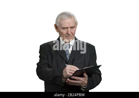 Tax inspector wrinting note on clipboard. Stock Photo