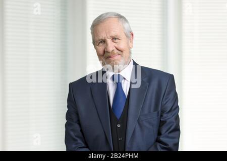 Smiling old man in suit portrait. Stock Photo