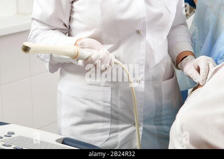 Cropped view of gynecologist holding transvaginal ultrasound wand to exam a woman Stock Photo