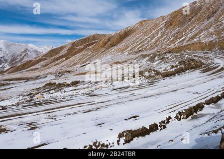 the gravel road on the snow mountain Stock Photo