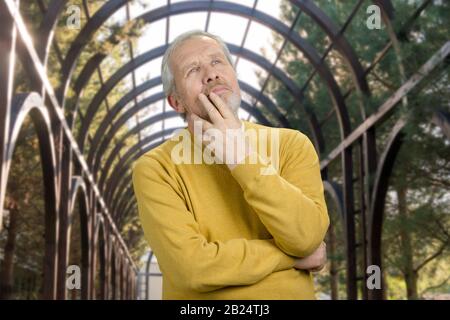 Portrait of thoughtful senior man is thinking. Stock Photo