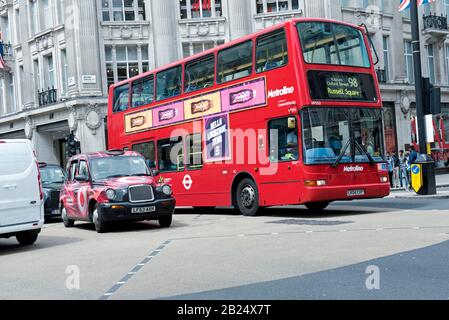 Number 98 red double decker bus destination Russell Square crrossing over Oxford Circus, Central London England Britain UK Stock Photo