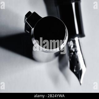 Close up of black fountain pen cap and nib.  Black and white. Stock Photo