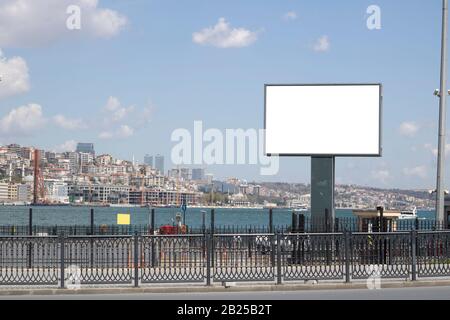 Blank white advertising sign close-up. In the background, the Bosphorus passes in the foreground. Stock Photo