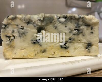 Gorgonzola cheese close up. Veined Italian blue cheese. Mold made with penicillum spores. Cooking delicacy ingredient Stock Photo