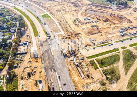aerial top down view on city construction site. building of new asphalt road in residential district Stock Photo