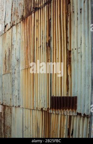 Rusting corrugated iron metal wall ideal as background wallpaper Stock Photo
