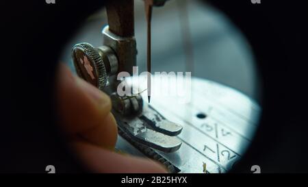 Thread a Needle on a Sewing Machine Close-up. Tailor Concept. Stock Photo