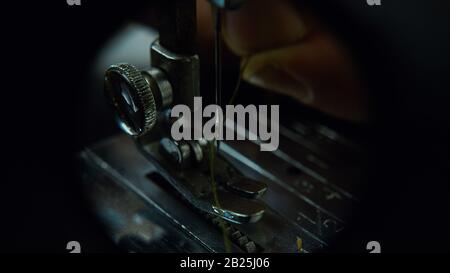 Thread a Needle on a Sewing Machine Close-up. Tailor Concept. Stock Photo