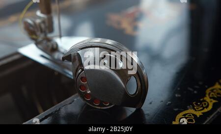 Bobbin housing or bobbin case on the bottom thread of a sewing machine.Tailor background and wallpaper. Stock Photo