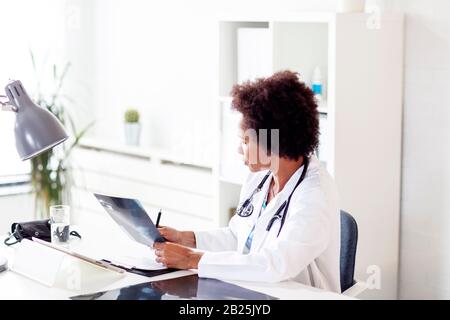 Afro american doctor in her office in hospital Stock Photo