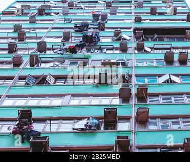 Facade of an apartment building with windows and air conditioning units Stock Photo
