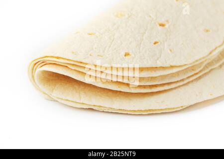Tortilla on a white isolated background. Corn tortilla or simply tortilla is a type of thin unleavened bread made from Hominy. Bread products Stock Photo