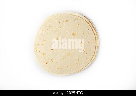 Tortilla on a white isolated background. Corn tortilla or simply tortilla is a type of thin unleavened bread made from Hominy. Bread products Stock Photo