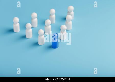 Blue leader the leader leads a group of employees in white to achieve the goal, personnel, and recruitment. The concept of leadership. Relationships i Stock Photo