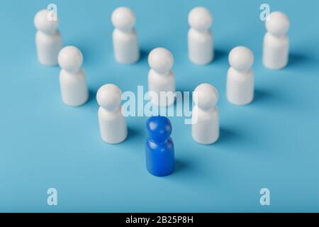 Blue leader the leader leads a group of employees in white to achieve the goal, personnel, and recruitment. The concept of leadership. Relationships i Stock Photo