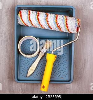 painting work concept. set of tools for painting and repairing walls. roller and brush. Stock Photo