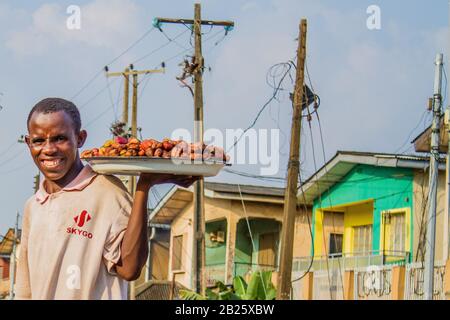 A kola-nut vendor on a street in Lagos, Nigeria. Stock Photo