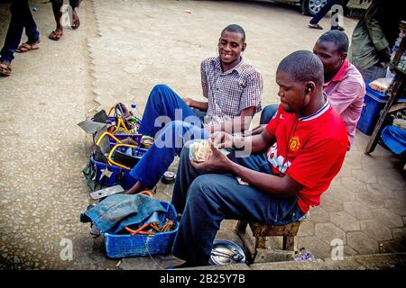 Shoe shiners on a street in Lagos, Nigeria. Stock Photo