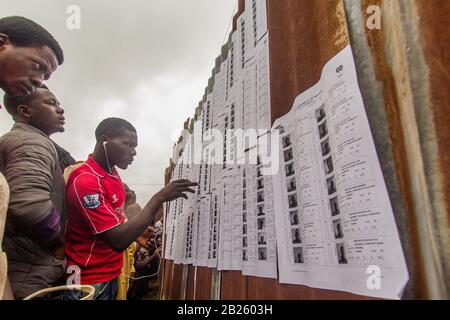 Voters check their name before voting at a polling station during the 2014 gubernatorial election in Osun State, Nigeria. Stock Photo