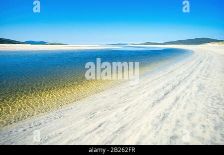 Sunlit sands and water at Luskentyre (Losgaintir) Beach on a beautiful Summer day in June with blue sky, Isle of Harris, Scotland, UK Stock Photo