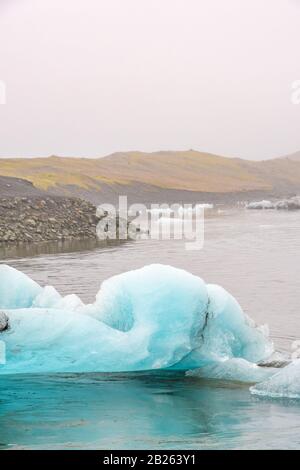 Joekulsarlon Glacier Lagoon ice floes in front of the lake shore line Stock Photo