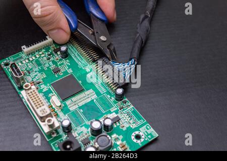 The process of repairing an electronic circuit board monitor. The work of the master electronic engineer Stock Photo